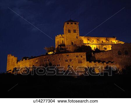 Picture -  Switzerland, Europe, valais, wallis, Sion, Rhone Valley, Fendant Wine Region, Church of Notre Dame de ValFre, 11th century, illuminated, evening, alps. Fotosearch