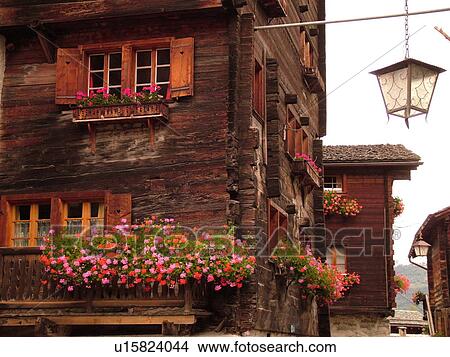 Picture -  Switzerland, Europe, valais, wallis, Val d'Anniviers, Grimentz, alpine village, old chalets, flowers, window boxes, street lamp. Fotosearch