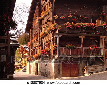 Switzerland, Europe, valais, wallis, Val d'Anniviers, Grimentz, old chalets along a narrow pedestrian street decorated with flowers, balconies View Large Photo Image Picture - Switzerland, Europe, valais, wallis, Val d'Anniviers, Grimentz, old chalets along a narrow pedestrian street decorated with flowers, balconies. Fotosearch