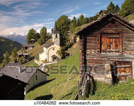 Stock Image -  Switzerland, Europe, valais, wallis, Val d'Anniviers, Chandolin, alpine village, chalets, church, mountainside. Fotosearch