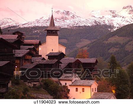 Switzerland, Europe, valais, wallis, Val d'Anniviers, Grimentz, alpine village, church, rooftops, sunset, snow-capped mountain peaks View Large Photo Image Stock Image - Switzerland, Europe, valais, wallis, Val d'Anniviers, Grimentz, alpine village, church, rooftops, sunset, snow-capped mountain peaks. Fotosearch