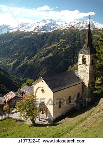 Stock Image -  Switzerland, Europe, valais, wallis, Val d'Anniviers, Chandolin, church, alpine village, snow-capped mountain peaks. Fotosearch