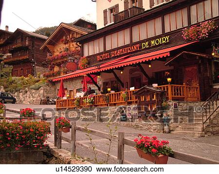 Stock Image -  Switzerland, Europe, valais, wallis, Val d'Anniviers, Grimentz, alpine village, Hotel Restaurant De Moiry, outdoor cafT. Fotosearch