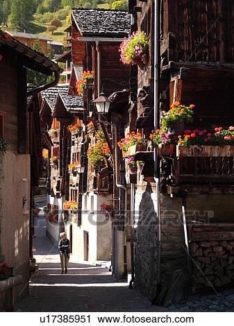 Switzerland, Europe, valais, wallis, Val d'Anniviers, Grimentz, old chalets along a narrow pedestrian street View Large Photo Image Stock Image - Switzerland, Europe, valais, wallis, Val d'Anniviers, Grimentz, old chalets along a narrow pedestrian street. Fotosearch