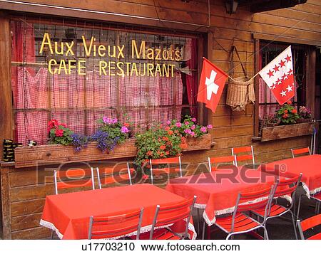 Switzerland, Europe, valais, wallis, Val D'Herens, Evolene, Aux Vieux Mazots CafT Restaurant, Swiss flag and flag of the Canton of valais, wallis, windows, windowboxes, flowers, outdoor cafT View Large Photo Image Stock Image - Switzerland, Europe, valais, wallis, Val D'Herens, Evolene, Aux Vieux Mazots CafT Restaurant, Swiss flag and flag of the Canton of valais, wallis, windows, windowboxes, flowers, outdoor cafT. Fotosearch