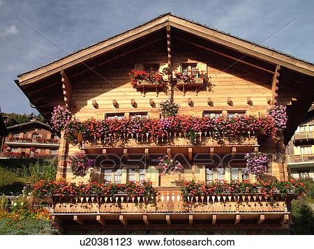 Stock Image -  Switzerland, Europe, valais, wallis, Val d'Anniviers, Grimentz, alpine village, mountain chalets decorated with flowers, window boxes. Fotosearch