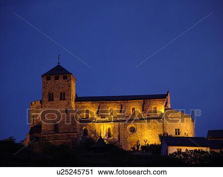 Stock Image -  Switzerland, Europe, valais, wallis, Sion, Rhone Valley, Fendant Wine Region, Church of Notre Dame de ValFre, 11th century, illuminated, evening, alps. Fotosearch