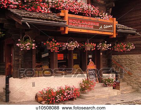 Switzerland, Europe, valais, wallis, Val d'Anniviers, Grimentz, chalet, Boulangerie, Patisserie decorated with pink and red geraniums View Large Photo Image Stock Photo - Switzerland, Europe, valais, wallis, Val d'Anniviers, Grimentz, chalet, Boulangerie, Patisserie decorated with pink and red geraniums. Fotosearch