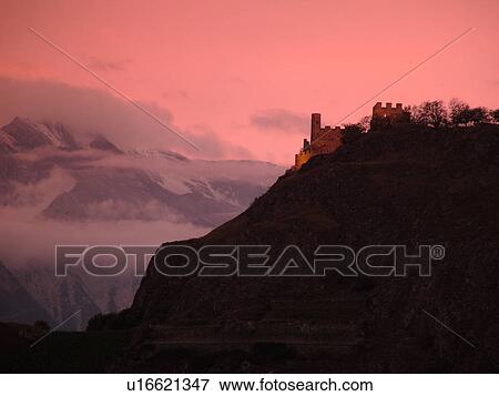 Stock Photo -  Switzerland, Europe, valais, wallis, Sion, Rhone Valley, Fendant Wine Region, ChGteau de Tourbillon, sunset, alps. Fotosearch