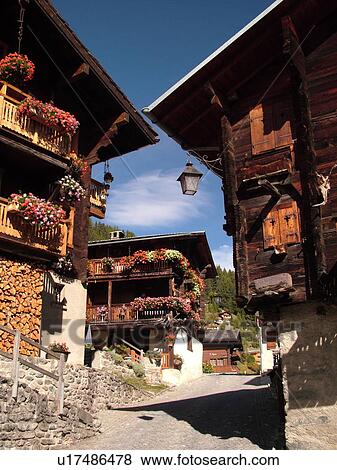 Stock Photo -  Switzerland, Europe, valais, wallis, Val d'Anniviers, Grimentz, old chalets along a narrow pedestrian street. Fotosearch