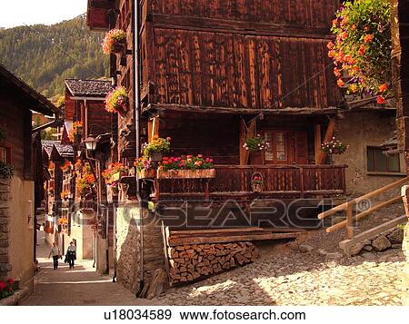 Switzerland, Europe, valais, wallis, Val d'Anniviers, Grimentz, old chalets along a narrow pedestrian street View Large Photo Image Stock Photo - Switzerland, Europe, valais, wallis, Val d'Anniviers, Grimentz, old chalets along a narrow pedestrian street. Fotosearch