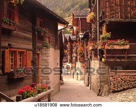 Switzerland, Europe, valais, wallis, Val d'Anniviers, Grimentz, old chalets along a narrow pedestrian street View Large Photo Image Stock Photo - Switzerland, Europe, valais, wallis, Val d'Anniviers, Grimentz, old chalets along a narrow pedestrian street. Fotosearch