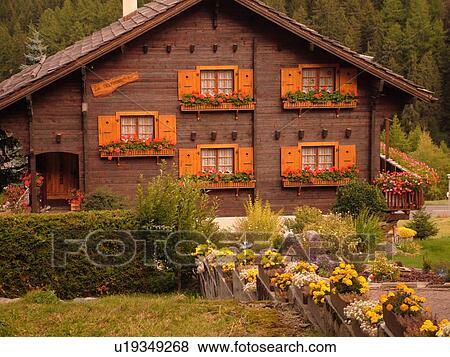 Stock Photo -  Switzerland, Europe, valais, wallis, Val d'Anniviers, Grimentz, alpine village, wooden chalet decorated with flowers in window boxes, wooden shutters. Fotosearch