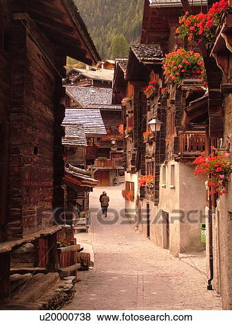 Switzerland, Europe, valais, wallis, Val d'Anniviers, Grimentz, old chalets along a narrow pedestrian street View Large Photo Image Stock Photo - Switzerland, Europe, valais, wallis, Val d'Anniviers, Grimentz, old chalets along a narrow pedestrian street. Fotosearch