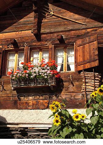 Stock Photo -  Switzerland, Europe, valais, wallis, Val d'Anniviers, Grimentz, close-up, old chalet, flowers in window box, sunflowers. Fotosearch