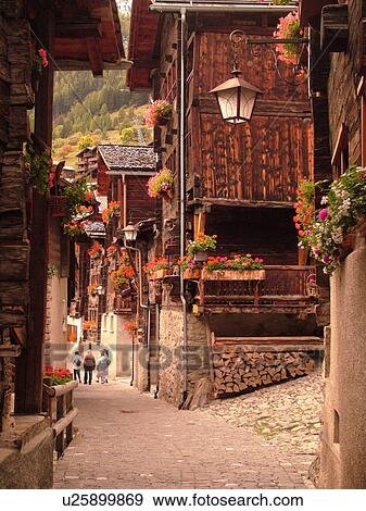 Stock Photo -  Switzerland, Europe, valais, wallis, Val d'Anniviers, Grimentz, old chalets along a narrow pedestrian street. Fotosearch