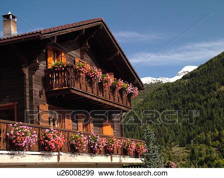 Stock Photo -  Switzerland, Europe, valais, wallis, Val d'Anniviers, St. Jean, chalet decorated with flowers. Fotosearch
