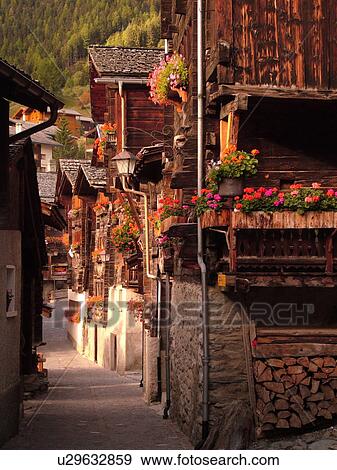 Switzerland, Europe, valais, wallis, Val d'Anniviers, Grimentz, old wooden chalets along a narrow pedestrian street View Large Photo Image Stock Photo - Switzerland, Europe, valais, wallis, Val d'Anniviers, Grimentz, old wooden chalets along a narrow pedestrian street. Fotosearch