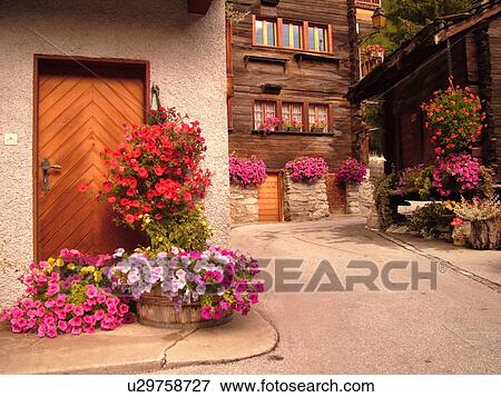 Stock Photo -  Switzerland, Europe, valais, wallis, Val D'Herens, Evolene, chalets decorated with flowers, windowboxes. Fotosearch
