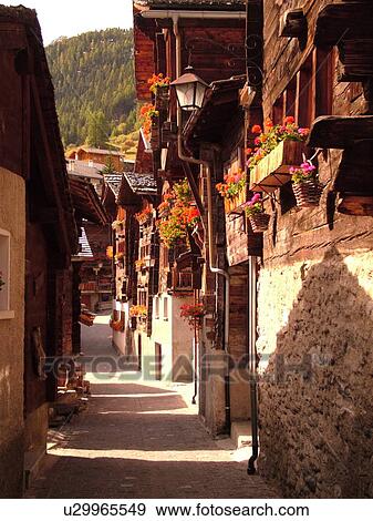 Switzerland, Europe, valais, wallis, Val d'Anniviers, Grimentz, old chalets along a narrow pedestrian street View Large Photo Image Stock Photo - Switzerland, Europe, valais, wallis, Val d'Anniviers, Grimentz, old chalets along a narrow pedestrian street. Fotosearch