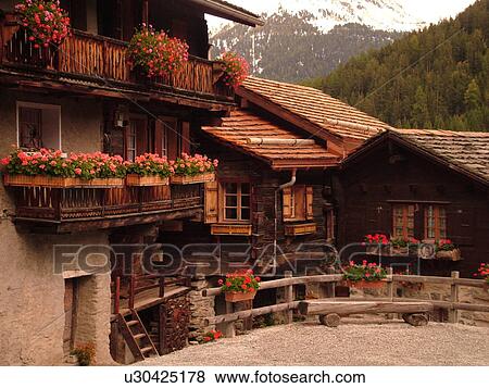 Switzerland, Europe, valais, wallis, Val d'Anniviers, Grimentz, alpine village, old chalets decorated with flowers View Large Photo Image Stock Photo - Switzerland, Europe, valais, wallis, Val d'Anniviers, Grimentz, alpine village, old chalets decorated with flowers. Fotosearch