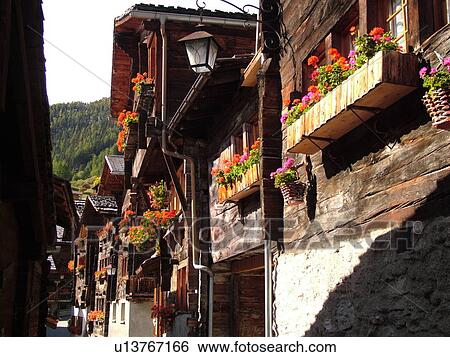 Switzerland, Europe, valais, wallis, Val d'Anniviers, Grimentz, old chalets along a narrow pedestrian street View Large Photo Image Stock Photograph - Switzerland, Europe, valais, wallis, Val d'Anniviers, Grimentz, old chalets along a narrow pedestrian street. Fotosearch