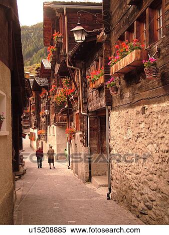 Switzerland, Europe, valais, wallis, Val d'Anniviers, Grimentz, old chalets along a narrow pedestrian street View Large Photo Image Stock Photography - Switzerland, Europe, valais, wallis, Val d'Anniviers, Grimentz, old chalets along a narrow pedestrian street. Fotosearch
