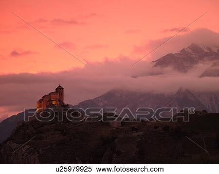 Stock Photography -  Switzerland, Europe, valais, wallis, Sion, Rhone Valley, Fendant Wine Region, Church of Notre Dame de ValFre, 11th century, sunset, alps. Fotosearch
