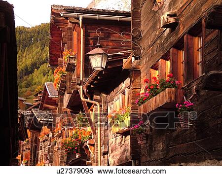 Stock Photography -  Switzerland, Europe, valais, wallis, Val d'Anniviers, Grimentz, old wooden chalets along a narrow pedestrian street, street light. Fotosearch