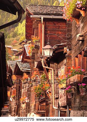 Switzerland, Europe, valais, wallis, Val d'Anniviers, Grimentz, old wooden chalets along a narrow pedestrian street, street light View Large Photo Image Stock Photography - Switzerland, Europe, valais, wallis, Val d'Anniviers, Grimentz, old wooden chalets along a narrow pedestrian street, street light. Fotosearch