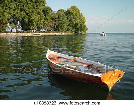 Stock Image -  Switzerland, Europe, Vaud, La Cote, Rolle, Lake Geneva, Lac Leman, wooden rowboat. Fotosearch
