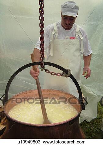 Stock Image -  Switzerland, Europe, Vaud, St. Cergues, Desalpe, festival, cheese making demonstration, fondue, large kettle . Fotosearch