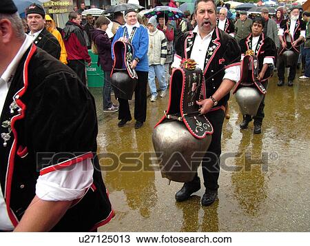 Stock Image -  Switzerland, Europe, Vaud, St. Cergues, La Desalpe, festival, cow bell ringers parading through town. Fotosearch