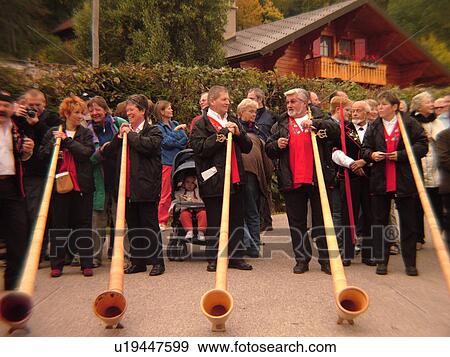 Stock Photo -  Switzerland, Europe, Vaud, St. Cergues, La Desalpe, festival, people playing alphorns. Fotosearch