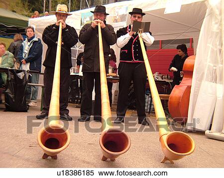 Stock Photography -  Switzerland, Europe, Vaud, St. Cergues, La Desalpe, festival, men playing alphorns. Fotosearch