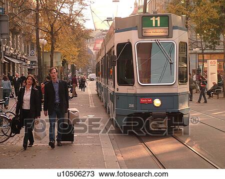 Stock Image -  Switzerland, Europe, Zurich, Zuerich, downtown, Bahnhofstrasse, trolley, tram, commuters. Fotosearch