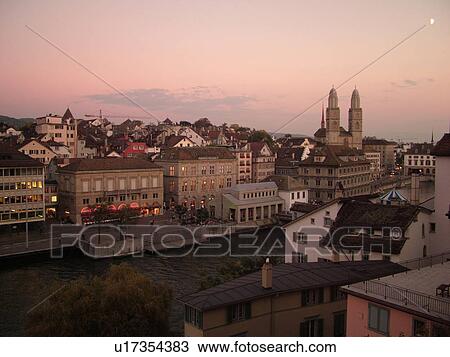 Stock Image -  Switzerland, Europe, Zurich, Zuerich, Limmat River, Grossmunster Cathedral, Limmatquai, sunset, aerial view. Fotosearch