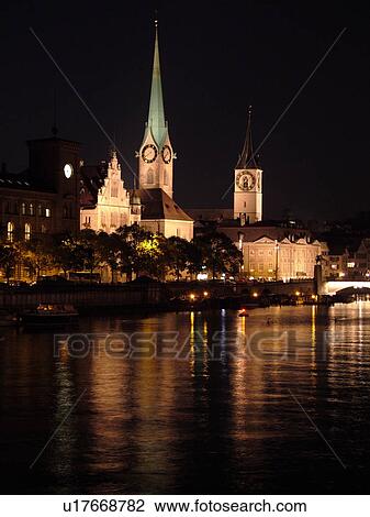 Stock Image -  Switzerland, Europe, Zurich, Zuerich, Limmat River, Fraumunster Church, St Peters Kirche, evening, moon. Fotosearch