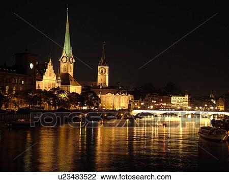 Stock Image -  Switzerland, Europe, Zurich, Zuerich, Limmat River, Fraumunster Church, St Peters Kirche, evening, moon. Fotosearch