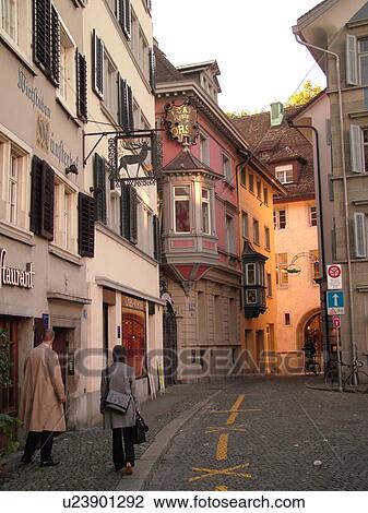 Stock Image -  Switzerland, Europe, Zurich, Zuerich, narrow cobblestone street. Fotosearch