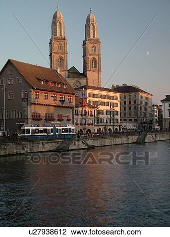 Stock Image -  Switzerland, Europe, Zurich, Zuerich, Limmat River, Grossmunster Cathedral, Limmatquai. Fotosearch