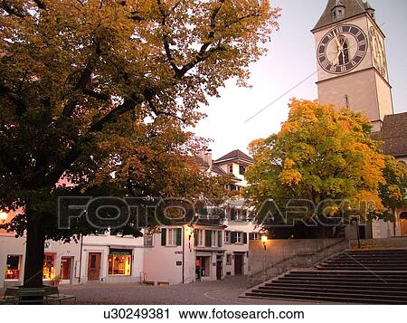 Stock Image -  Switzerland, Europe, Zurich, Zuerich, St. Peters Kirche, clock tower, evening. Fotosearch