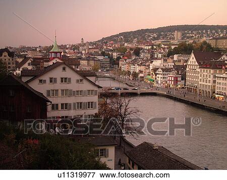 Stock Photo -  Switzerland, Europe, Zurich, Zuerich, Limmat River, sunset, aerial view. Fotosearch