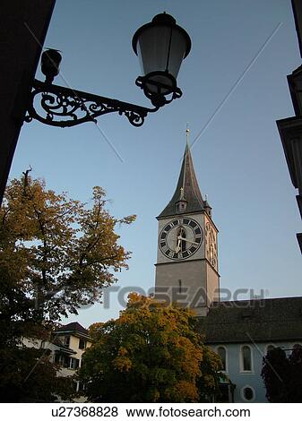 Stock Photo -  Switzerland, Europe, Zurich, Zuerich, St. Peters Kirche, clock tower, street lamp. Fotosearch