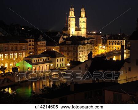 Stock Photography -  Switzerland, Europe, Zurich, Zuerich, Limmat River, Limmatquai, Grossmunster Cathedral, evening, aerial view. Fotosearch