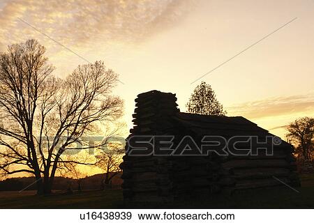 Stock Photo -  Valley Forge, PA, Pennsylvania, Valley Forge National Historical Park, log hut, sunset. Fotosearch