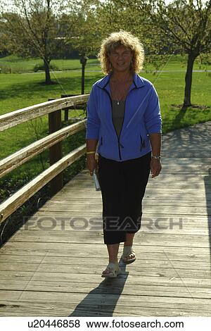 West Chester, PA, Pennsylvania, Hershey's Mill Chester County, 50 year old woman walking across a bridge, recreation path View Large Photo Image Stock Photo - West Chester, PA, Pennsylvania, Hershey's Mill Chester County, 50 year old woman walking across a bridge, recreation path. Fotosearch
