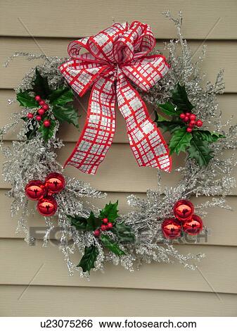 Stock Photograph -  West Chester, PA, Pennsylvania, Hershey's Mill Chester County, silver Christmas wreath with red balls. Fotosearch