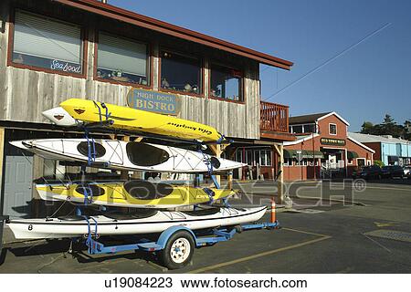 Stock Image -  Bandon, OR, Oregon, Pacific Ocean, Old Town Bandon, sea kayaks on trailer. Fotosearch