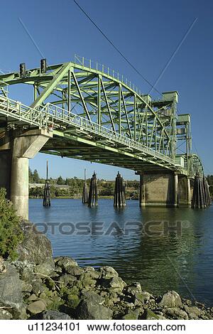 Stock Image -  Bandon, OR, Oregon, Pacific Ocean, Coquille River, Coquille River Bridge. Fotosearch